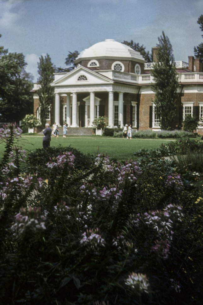 Free image of Group of people walking by a Monticello and large garden, USA