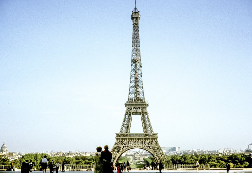 Free image of People looking at the Eiffel Tower on a clear day in Paris, France