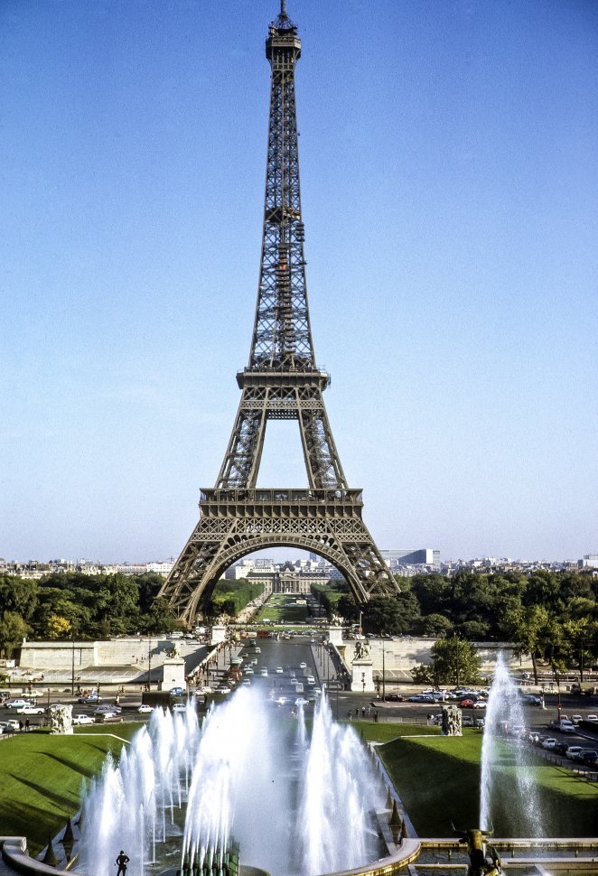 Free image of Eiffel Tower in the distance with fountains and traffic, Paris, France