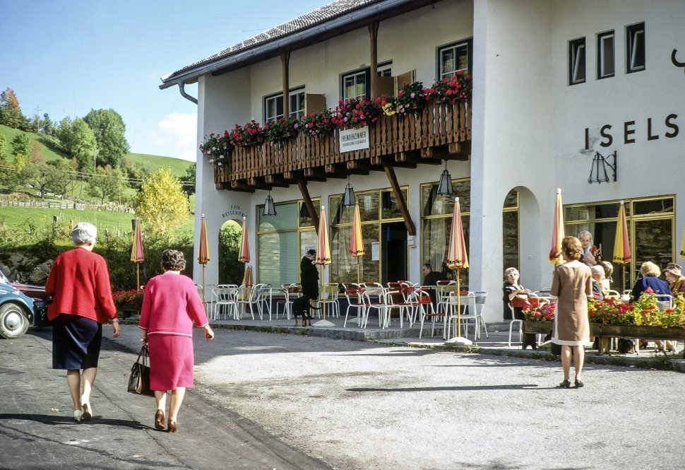 Free image of Women walking towards a restaurant entrance.