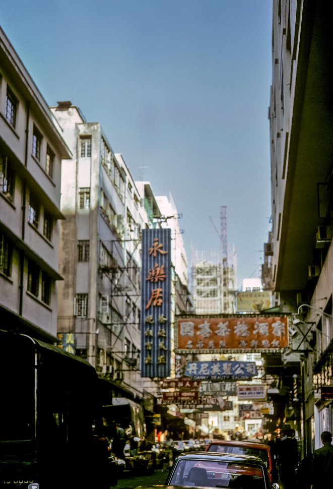 Free image of Signs lining a busy street, circa 1974, Hong Kong, China