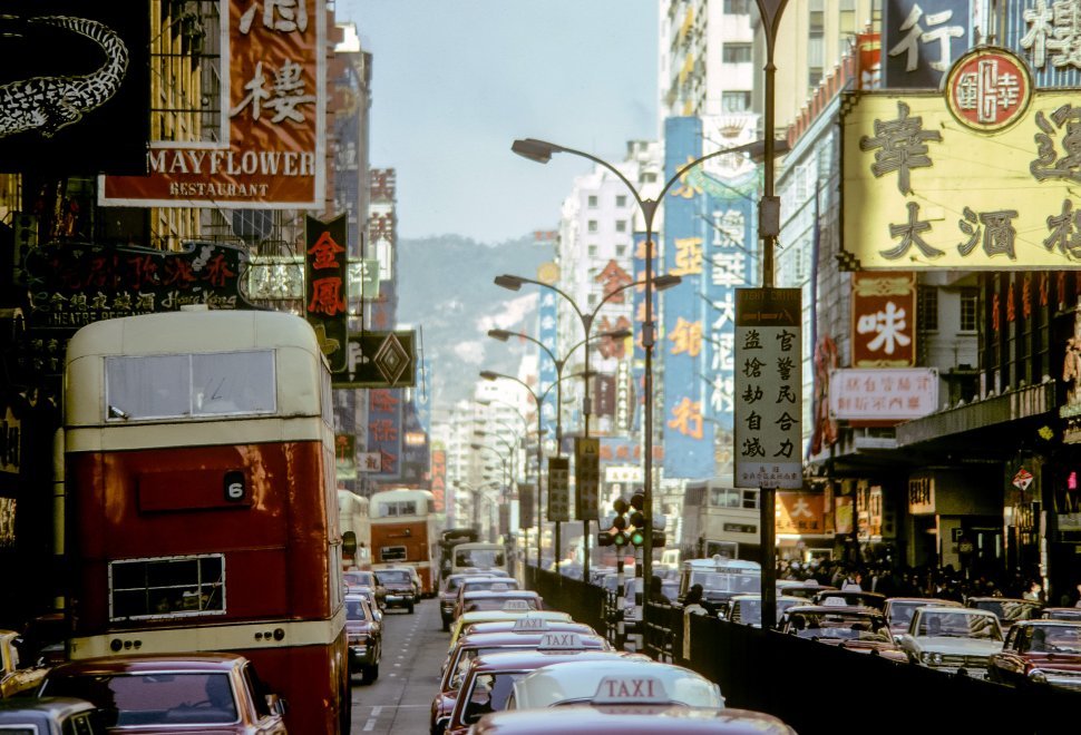 Free image of Busy city street scene with buildings, signs and traffic, circa 1974, Hong Kong, China