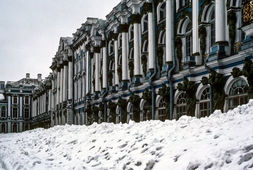 Free image of Snow drifts up aginst palace facade.