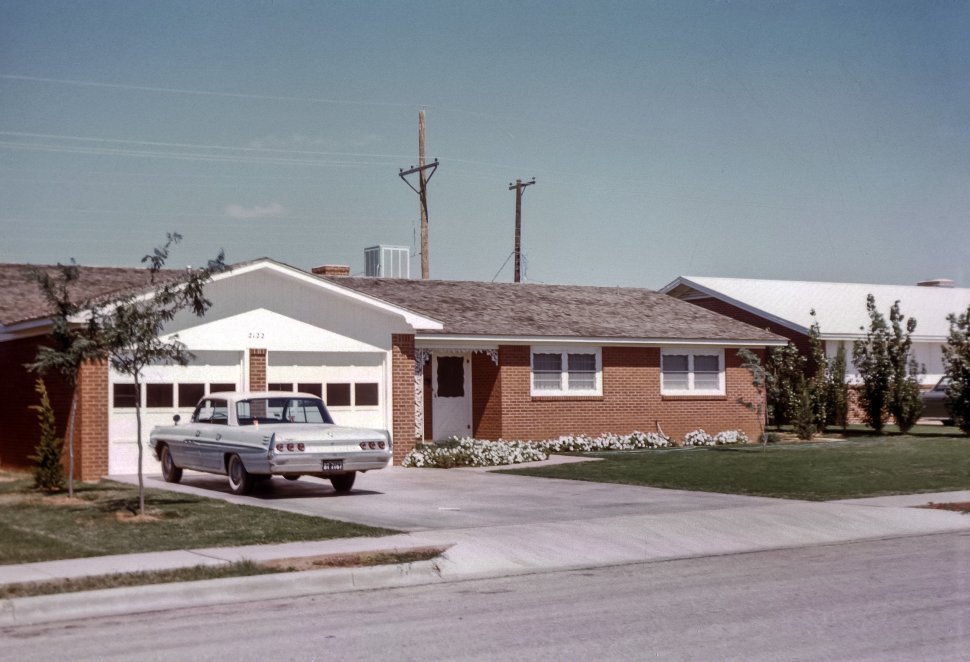 Free image of Vintage car parked in the driveway of a suburban home, USA