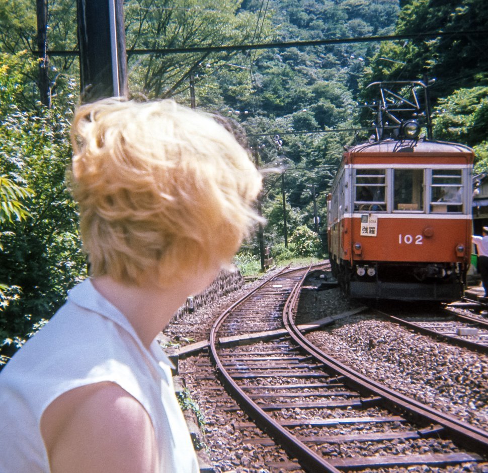 Free image of Woman watching a trolley and conductor arriving at the station, Europe