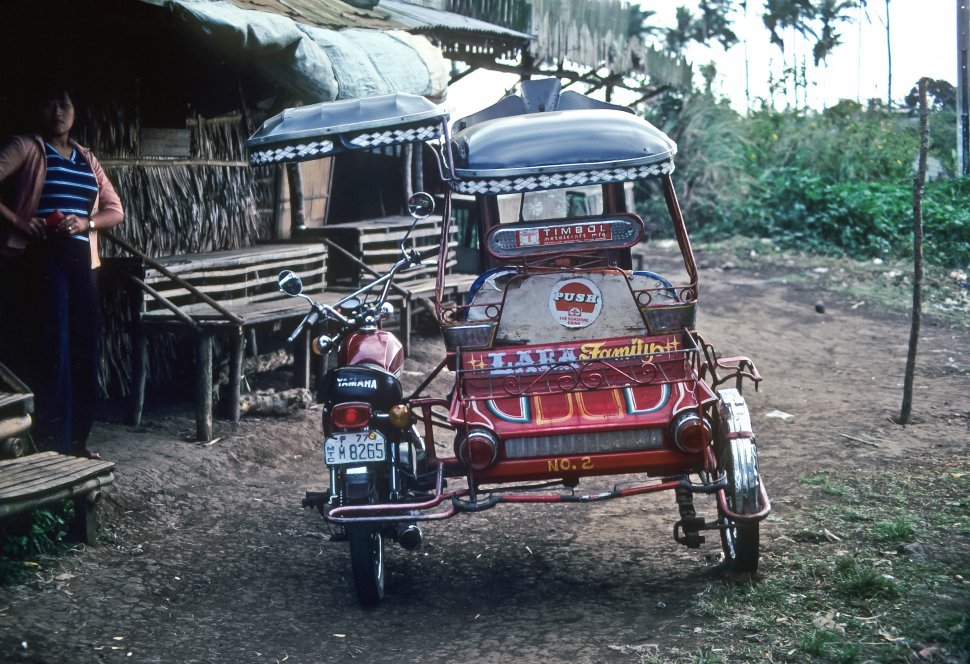 Free image of Motorcycle sidecar brightly decorated and parked outside a rural restaurant, Brazil