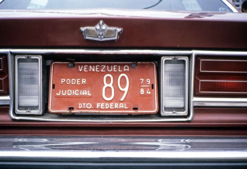 Free image of Close up of an official judge s red car and license plate, Venezuela