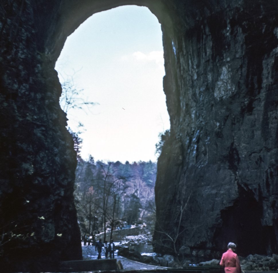 Free image of Huge stone arch with tourists walking through it. Natural Bridge, Virginia, USA