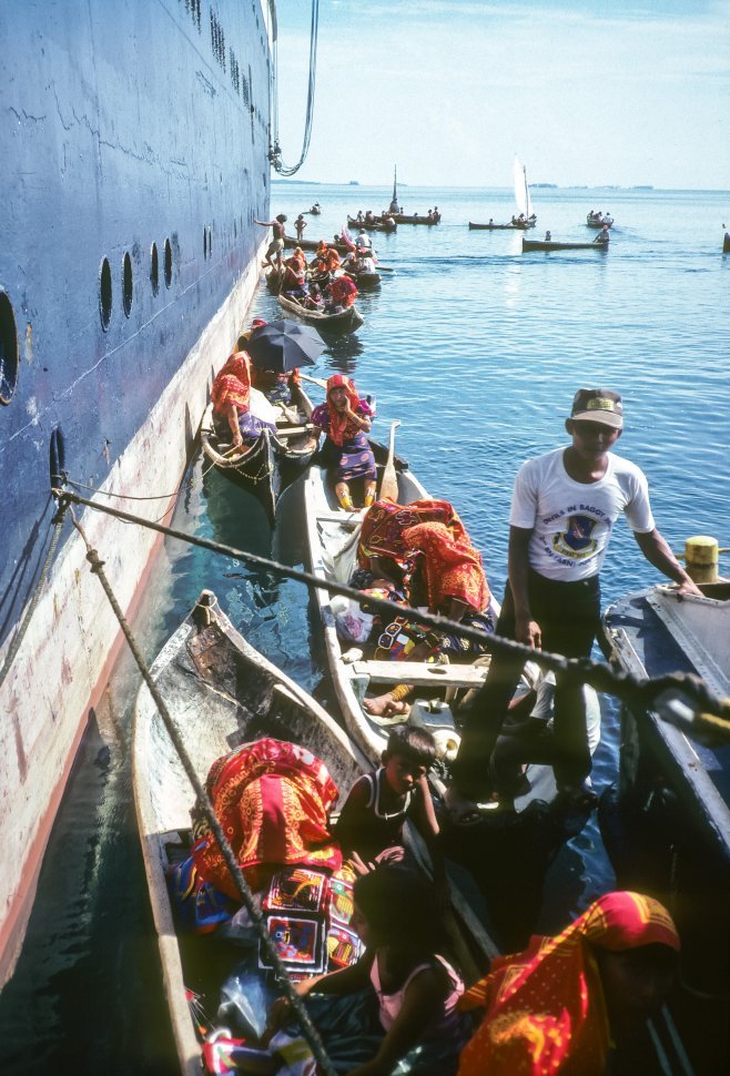 Free image of Families selling textiles from a small boat to tourists, Ecuador