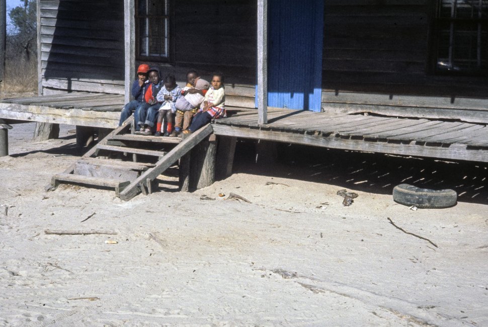 Free image of Portrait of smalll children sitting on a front step.